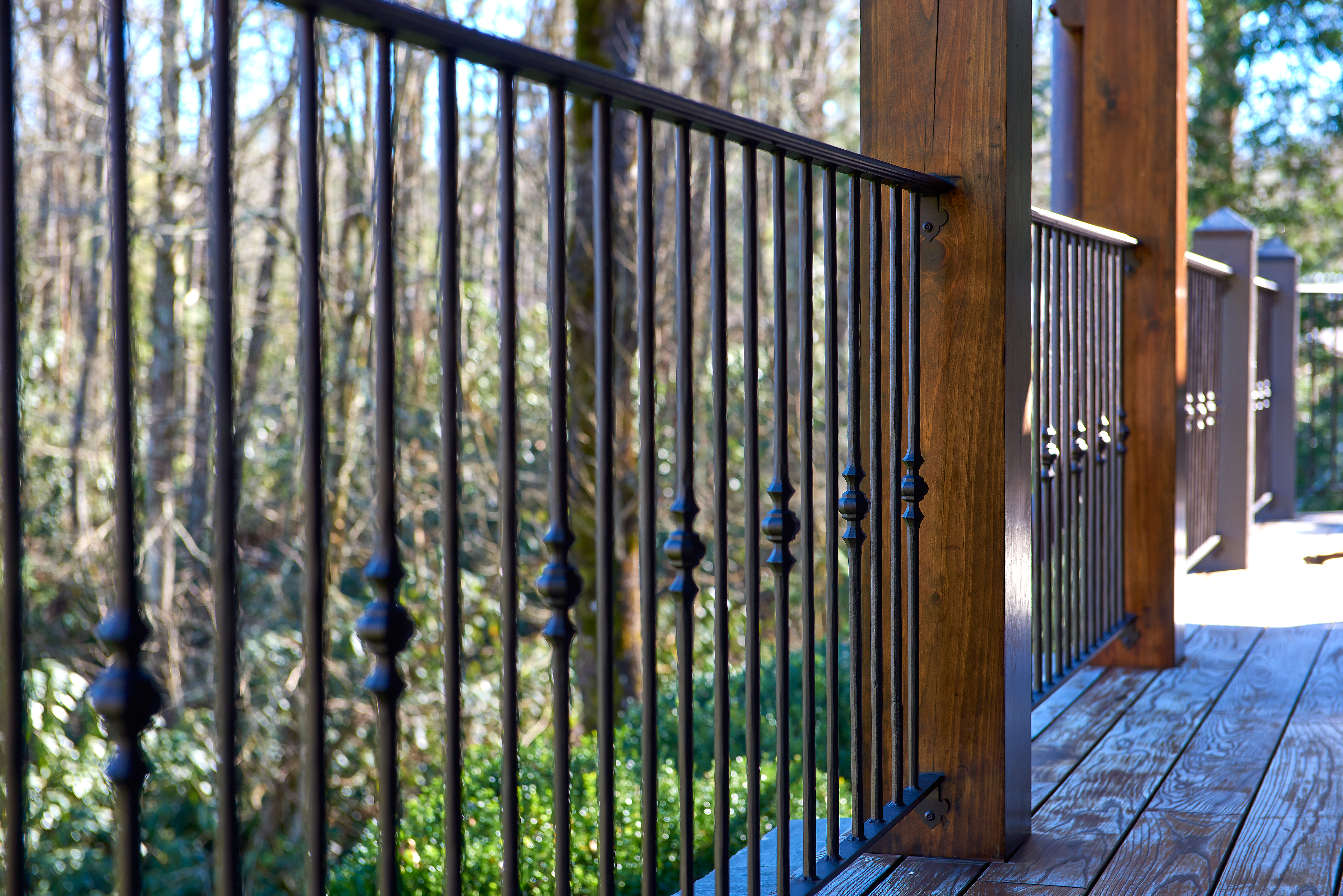 ornamental metalwork railing wooden deck forest